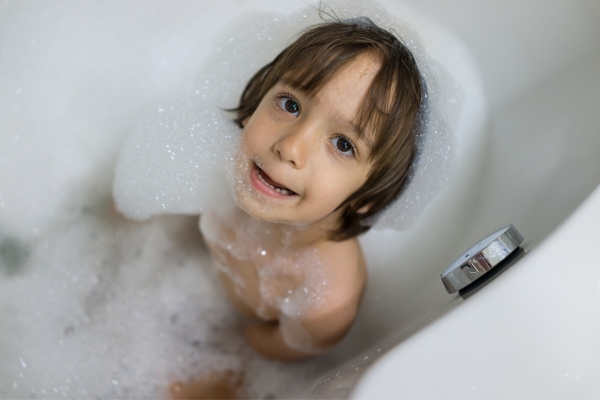 little boy having bubble bath